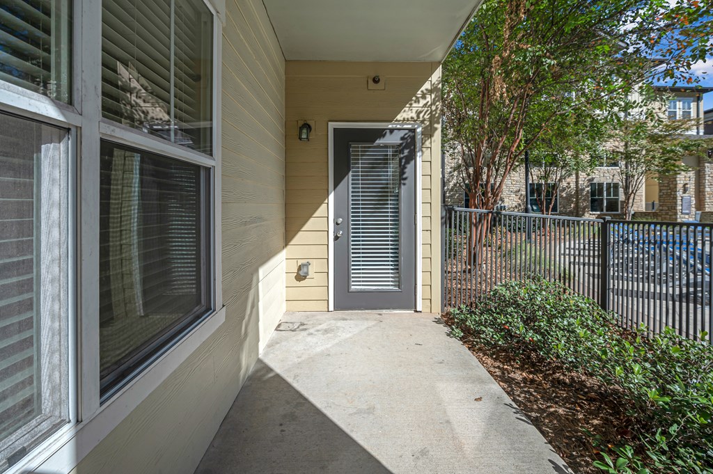 A house with a grey door and a grey fence.